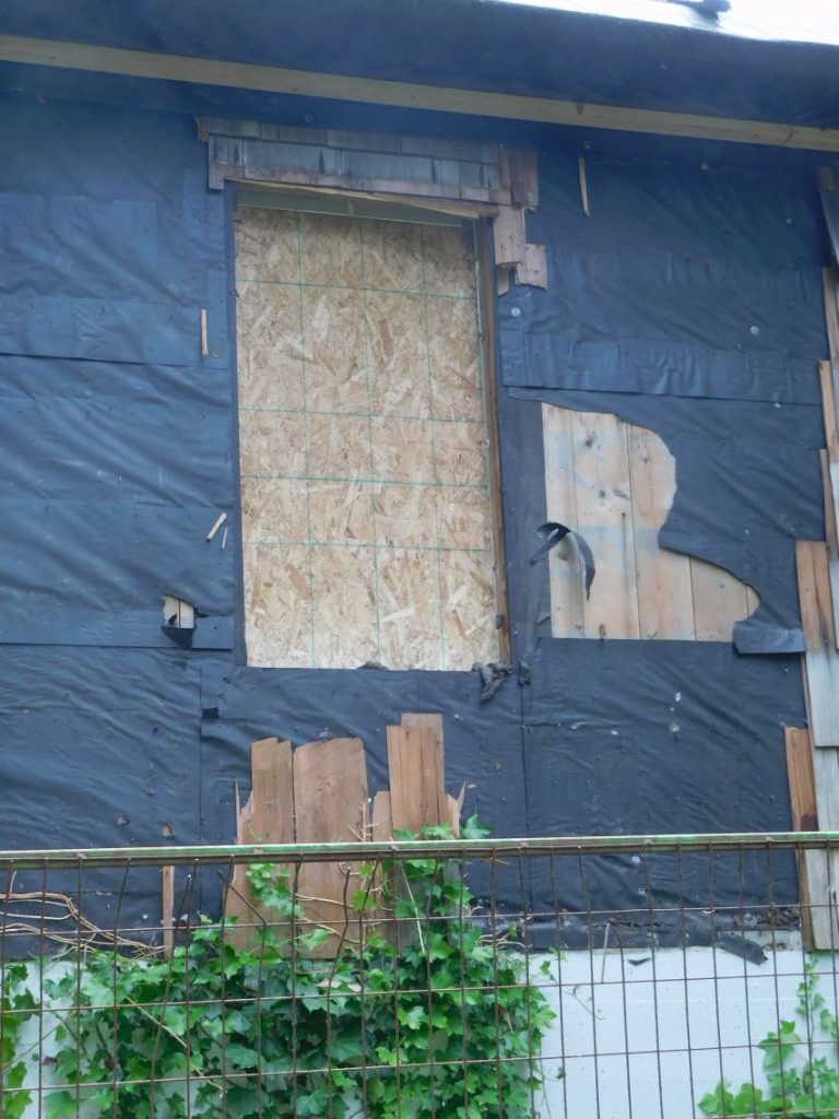 Closeup of back of Shakesides showing original window frame and shakes removed
